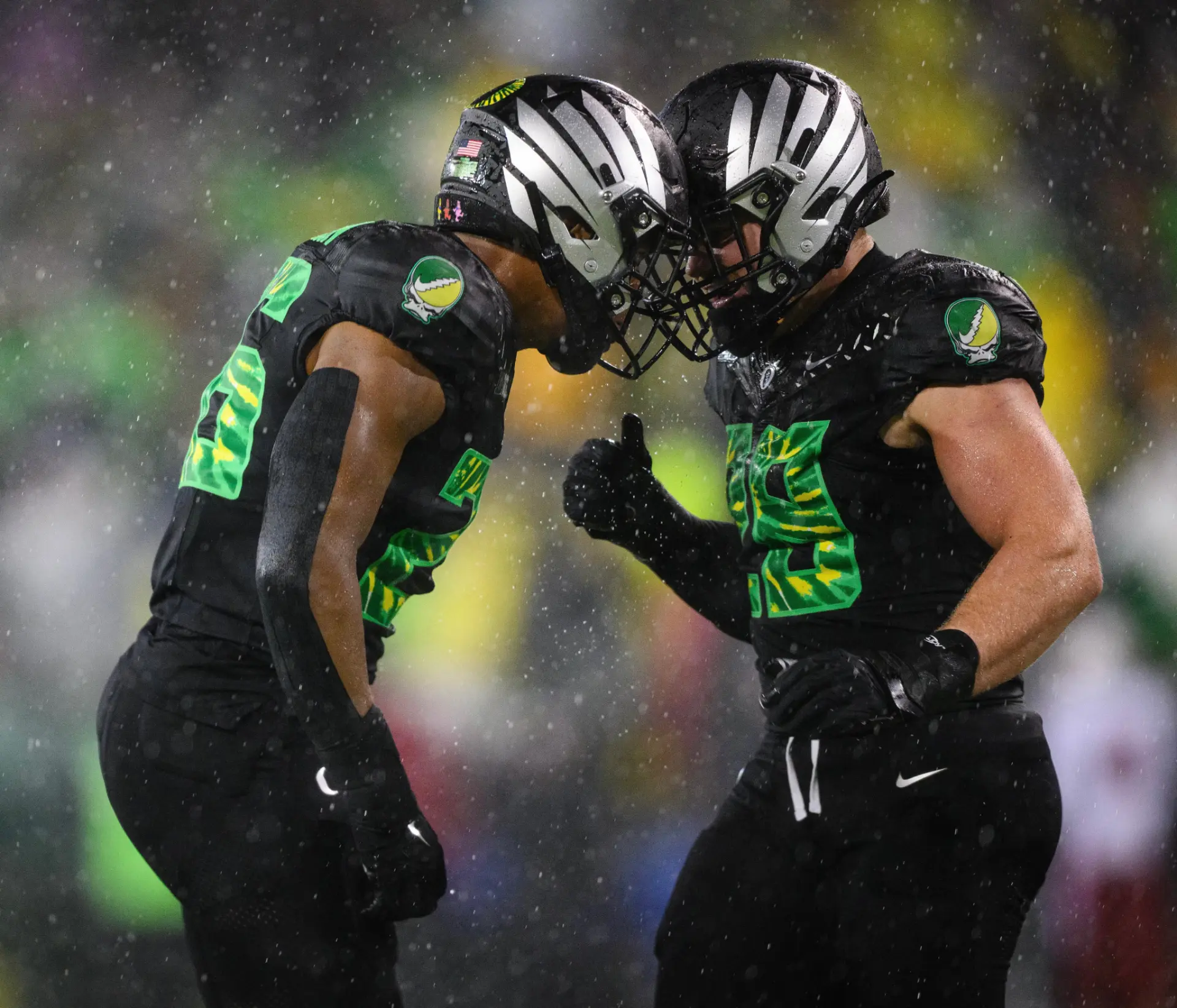 Oregon players celebrating in the rain